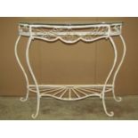 A cream painted cast metal vintage hall table with serpentine outline raised on simple shaped