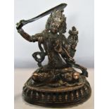 A Nepalese copper seated Manjushri with sword in right hand and lotus in the left hand, 11cm