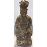 An antique Chinese carved wooden figure of a seated man, 20.5cm high