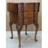 A small reproduction Queen Anne style figured walnut veneered drop leaf lamp table, the serpentine