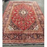 A Central Persian Kashan Carpet with book cover design in red, blue and natural wool tones with