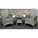 A pair of contemporary synthetic all weather woven cane style garden chairs and matching table