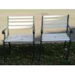 A pair of garden open armchairs with painted wooden slatted seats and cast iron supports, 60 cm wide