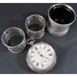 A H. Samuel silver pocket watch, two silver napkin rings and a silver salt with blue glass liner,