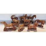 A group of nine vintage carved wood Chinese horses with beaded eyes each approximately 10cm wide.