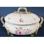 An early 19th century Derby tureen and cover with floral sprays, raised on gilded lions mask and paw