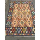 A Chobi kilim with geometric diamond design in multicoloured tones and a deep blue border, 182cm x