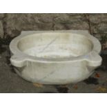 An old white marble and grey veined basin of oval form with pronounced lugs, approx 50cm wide x 40cm