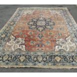 A large Malayer carpet, faded, with a central medallion with an overall floral pattern on pink