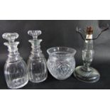 Nine antique decanters of varying shapes and sizes, a cut glass table lamp, and an ovoid vase. 11