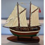 A wooden model of a two masted fishing boat, simply named Paul, on a wooden stand. 48cm max high x