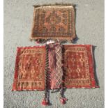 A Turkmen flat pannier bag and an Afghan flat weave mat, both with geometric indigo patterns on a
