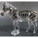 Swarovski crystal glass ornaments, a ballerina under a glass dome, and a Zebra, both in their