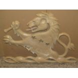 A cast resin rampant lion wall plaque, 96 cm wide x 68 cm high