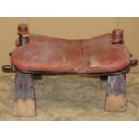 A vintage camel stool with leather pad seat (af)