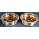 A pair of Edwardian silver plated wine coasters, 15cm diam.