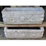 A pair of weathered cast composition stone rectangular flower troughs repeating scrolling foliate
