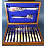 An antique oak canteen of silver plated fish knives and forks for six settings complete with serving