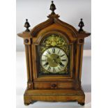 A late 19th century German bracket clock with walnut case, broken arch dial and Ting Tang strike