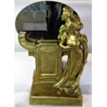 An early 20th style mantel piece oval mirror in a gold finished decorative plinth with a woman to