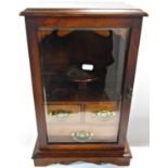 A Victorian oak smokers cabinet with a full glazed door revealing three drawers and three mixing