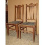 A set of four (2&2) oak restrained Arts & Crafts high slat back dining chairs with upholstered pad
