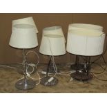 Two pairs of contemporary polished chrome table lamps of varying design in the Art Deco style