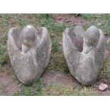 A matched pair of novelty weathered cast composition stone garden planters in the form of swans,