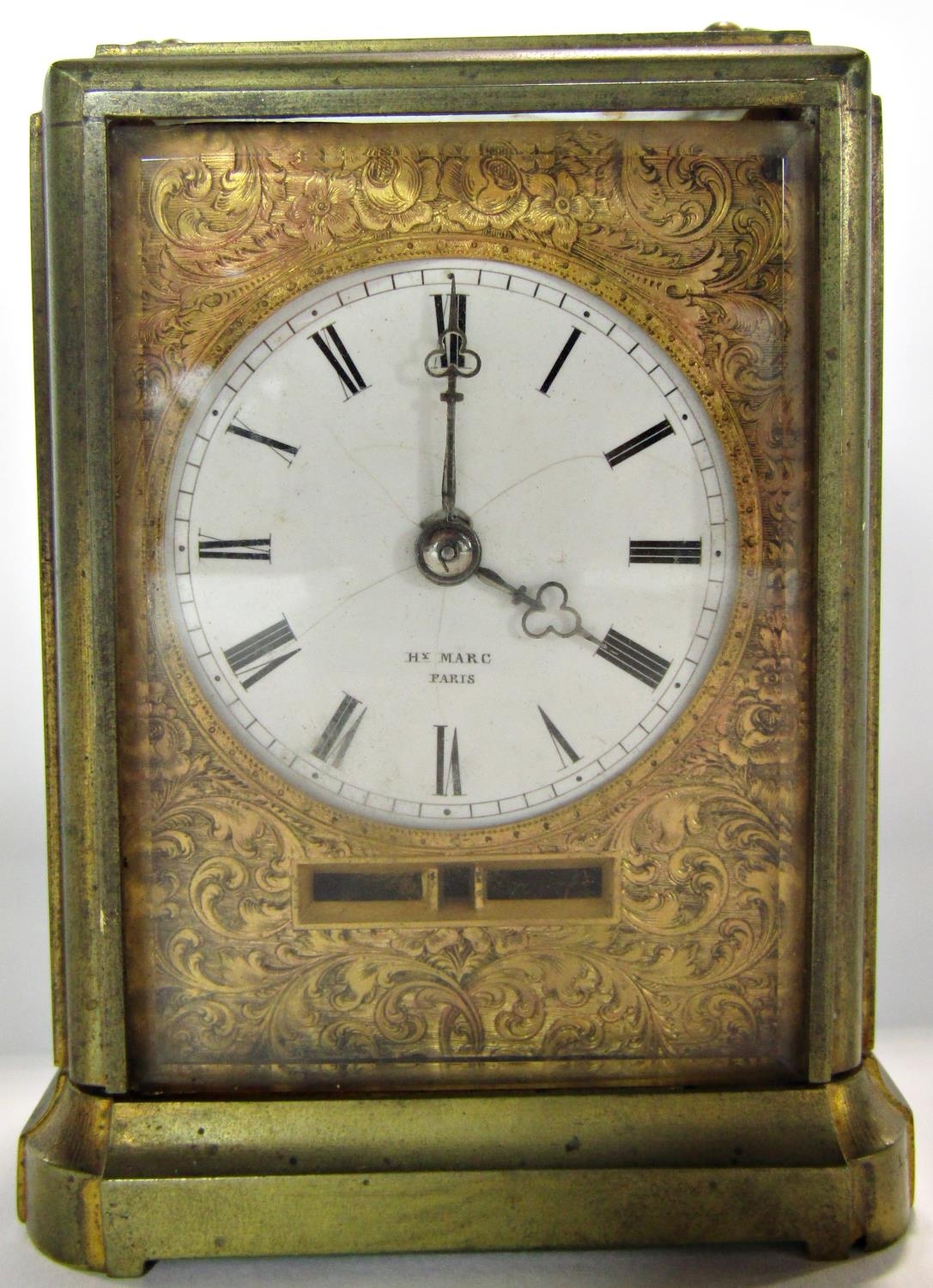 a late 19th century French eight day carriage clock with circular enamel dial set within a chased