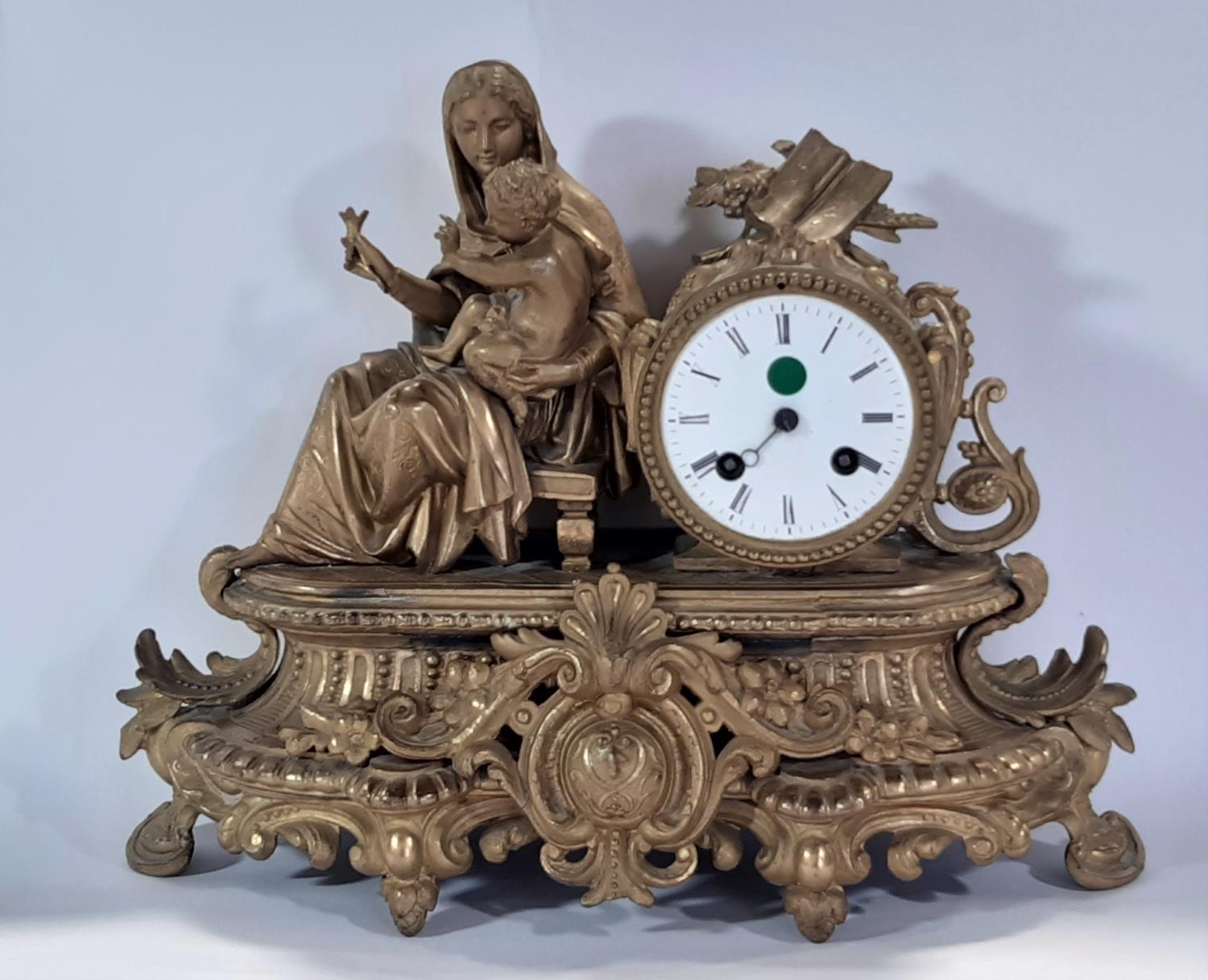 19th century gilt brass mantle clock, the decorative case showing mother and child with eight day