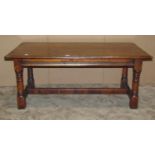 A good quality reproduction old English style oak occasional table of rectangular form raised on gun