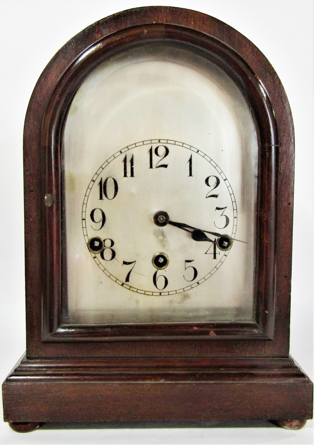 A mahogany bracket or shelf clock the domed case enclosing a German movement with silvered dial 33cm