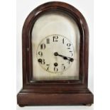 A mahogany bracket or shelf clock the domed case enclosing a German movement with silvered dial 33cm