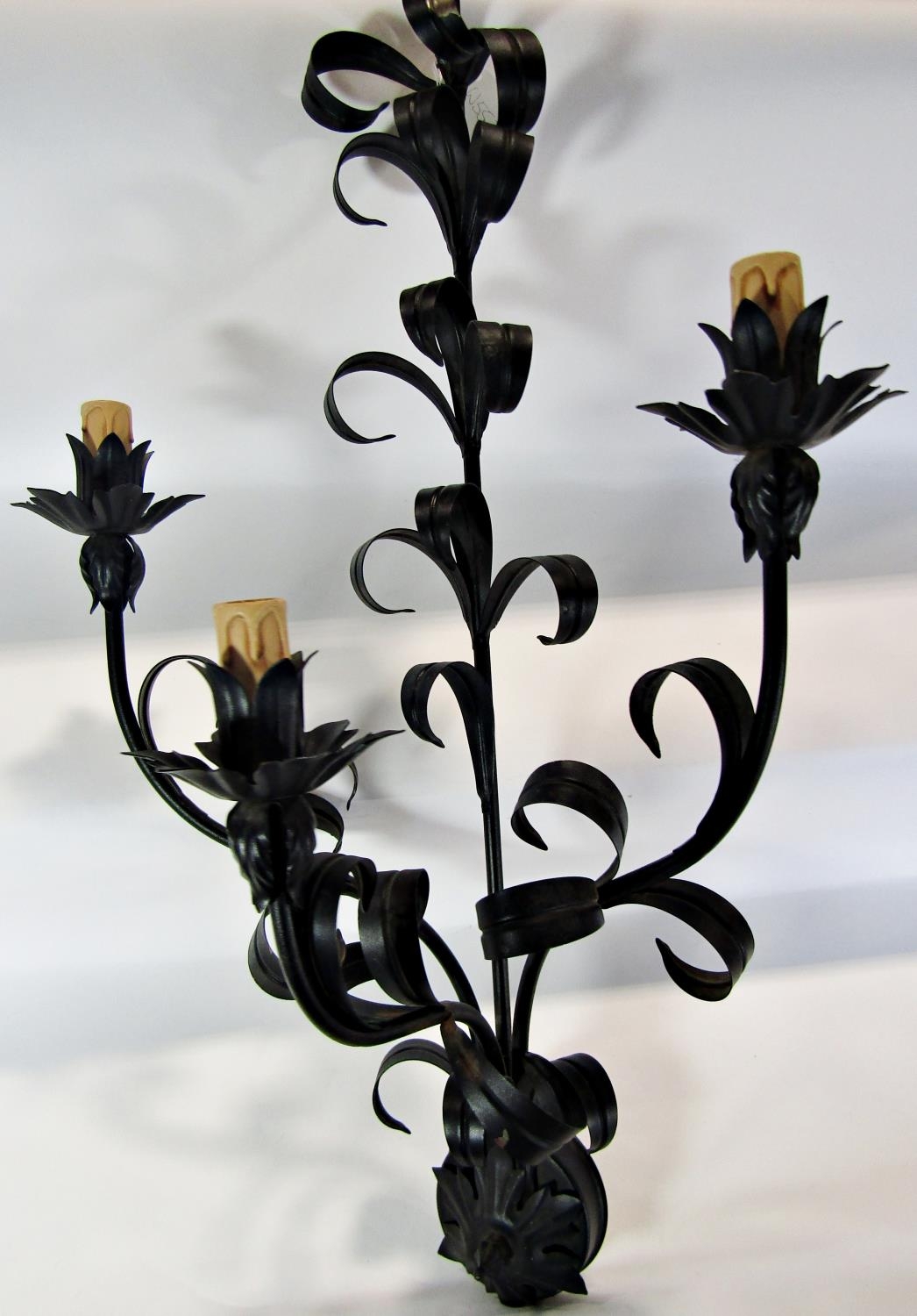 A pair of scrolled wrought iron wall sconces with three branches and foliate detail, 76 cm long - Image 2 of 2