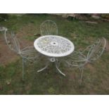 A cast aluminium garden terrace table with pierced scrolling foliate panelled top and swept