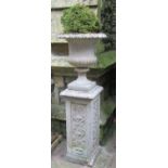 A weathered cast composition stone campana shaped garden urn with flared egg and dart rim, fixed