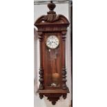 A 19th century oak cased Vienna style wall clock with twin train weight driven movement by Gustav