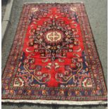 A North West Persian Tafresh Rug with central medallion and symmetrical flora and fauna design on