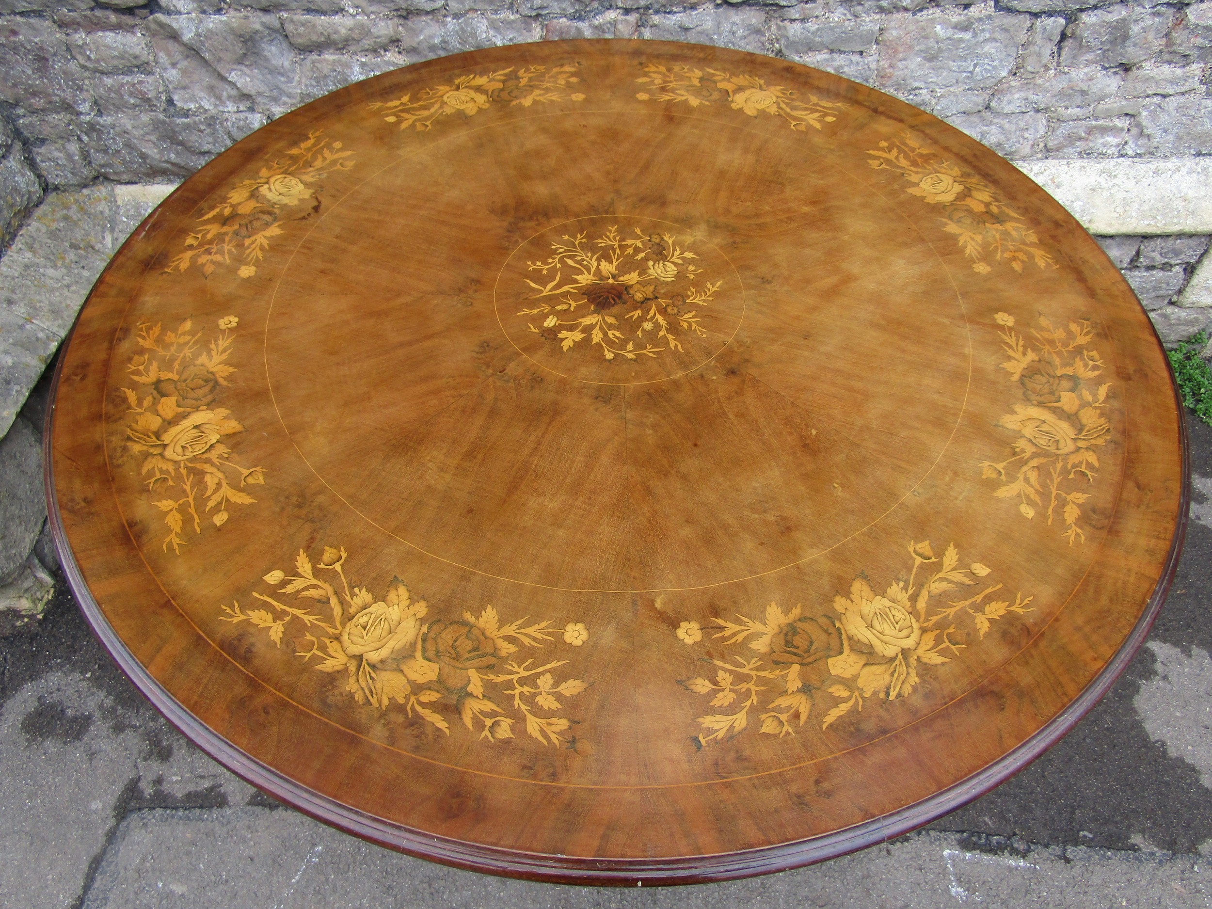 A Victorian style circular breakfast table with inlaid floral marquetry detail raised on a squat - Image 2 of 2