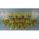 Fifteen near matching pale olive green spiral beehive wine glasses of varying sizes, and two similar
