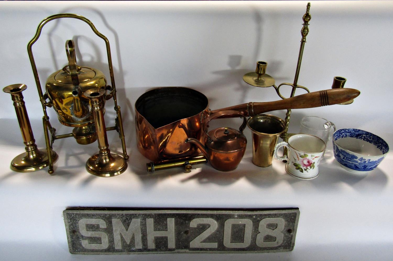 A mixed selection of copper and brassware including brass kettle on stand, copper kettle, a copper