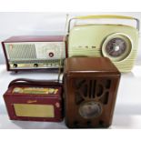 A group of retro vintage radios including a Roberts radio, DAB radio, Bush dial radio, a wooden 1934