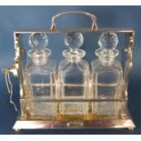 A Betjemanns Patent silver plated three bottle tantalus 30cm w x 30cm h. (Lock as found)