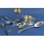 A mixed selection of silver consisting of three teaspoons with gold clubs, a tea strainer on a later