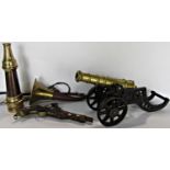 A miniature brass barrelled and cast iron field canon, a fireman's copper and brass hose nozzle, a