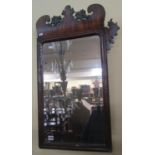 A Georgian mahogany Swansea type mirror the frame with fretted outline enclosing a bevelled edge