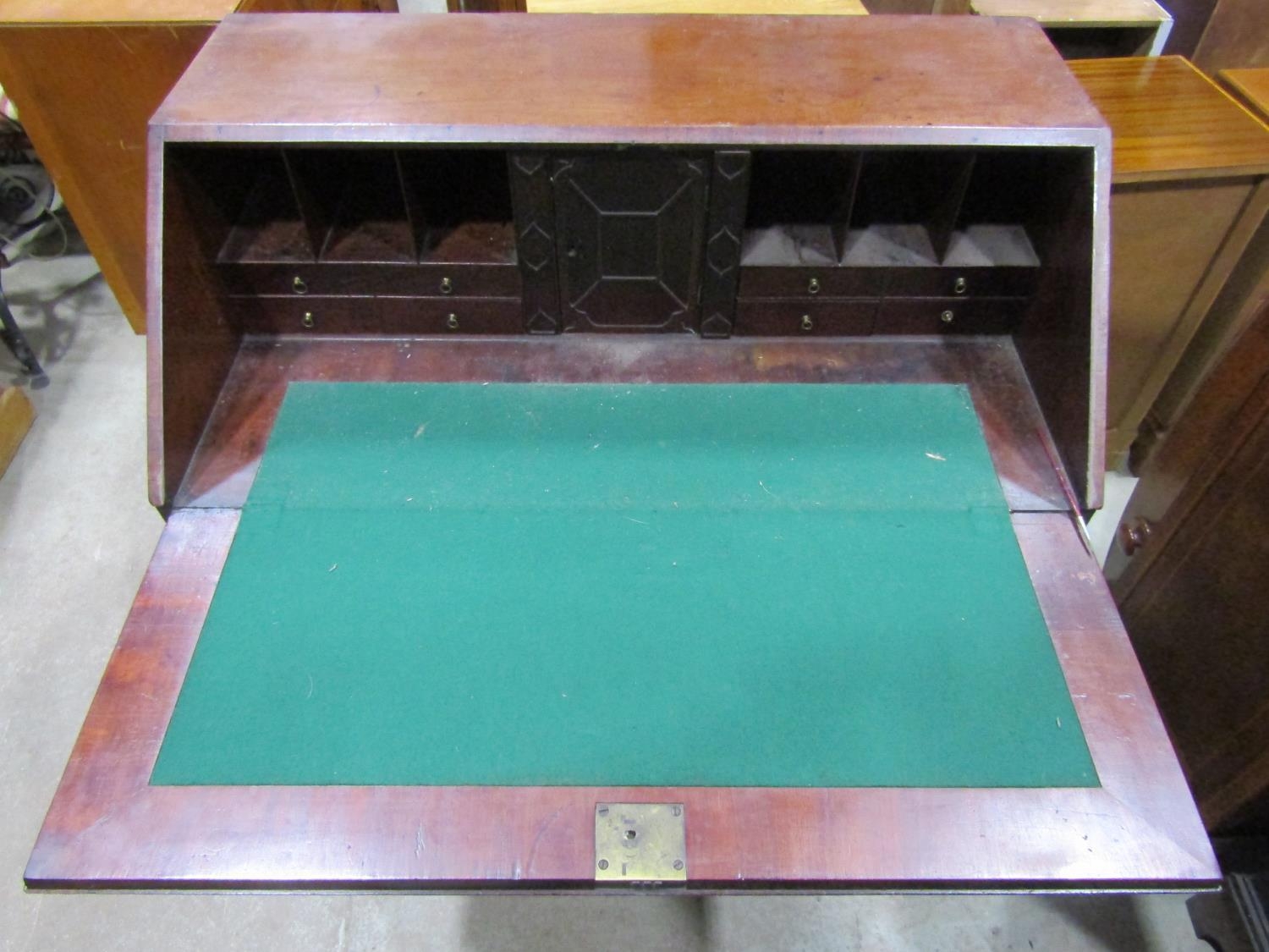 A Georgian mahogany bureau, the fall flap enclosing a fitted interior of small drawers, pigeon holes - Image 2 of 3