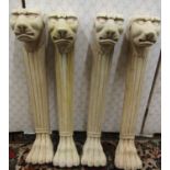 Four carved hardwood column supports with lion mask and lions paw feet, 58cm high