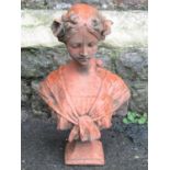A cast composition stone head and shoulder bust of a maiden with faux terracotta finish, 47 cm high