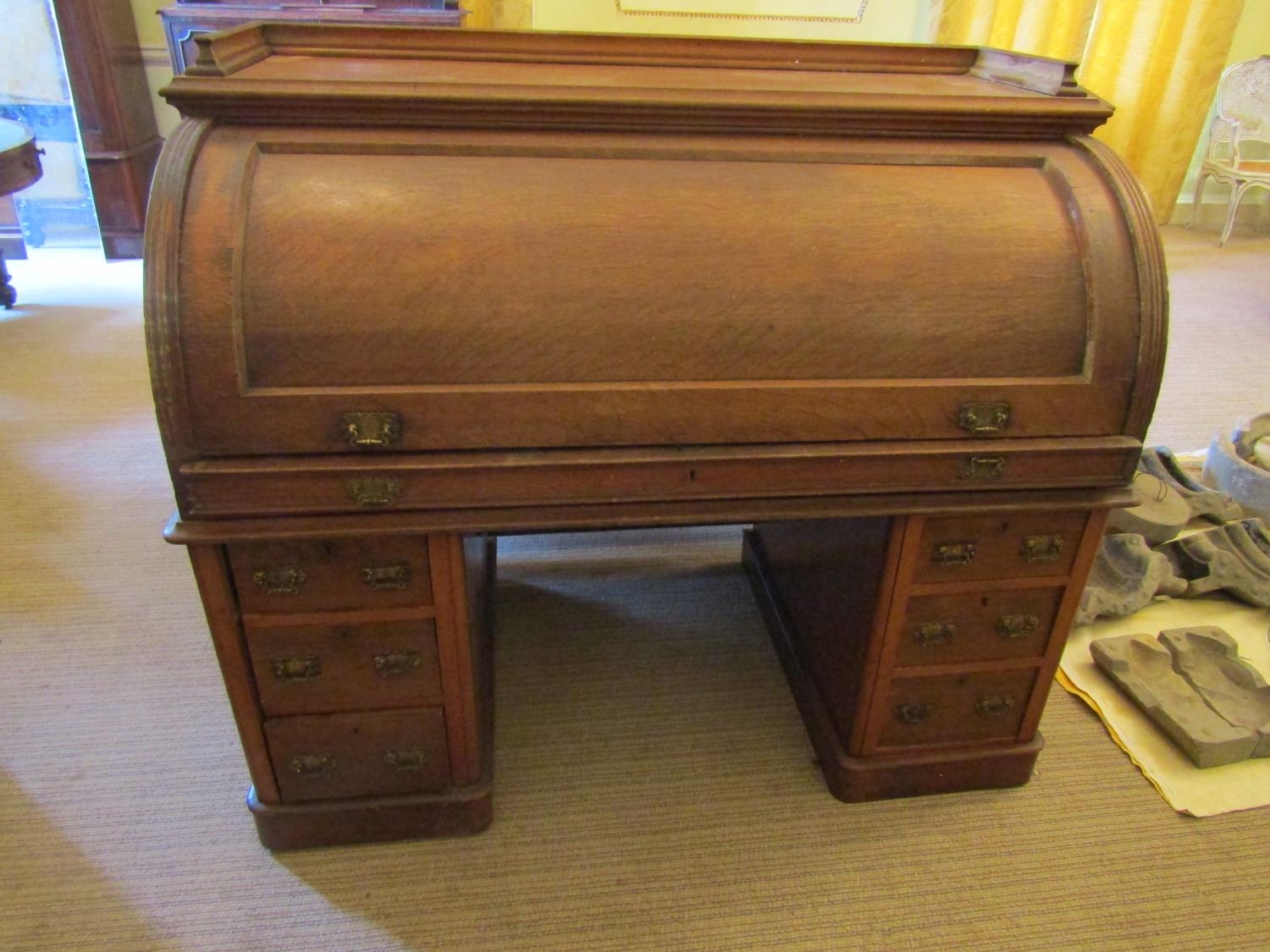 To be viewed at and collected from Nibley House GL11 6DL: A Victorian oak cylinder top desk